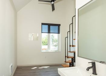A bathroom with a window and a sink.